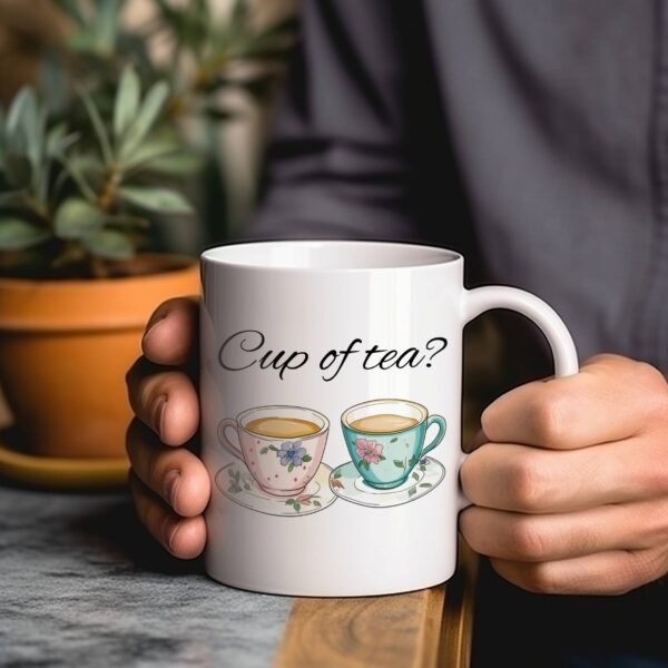 cup of tea mug held in two hands by man with plants