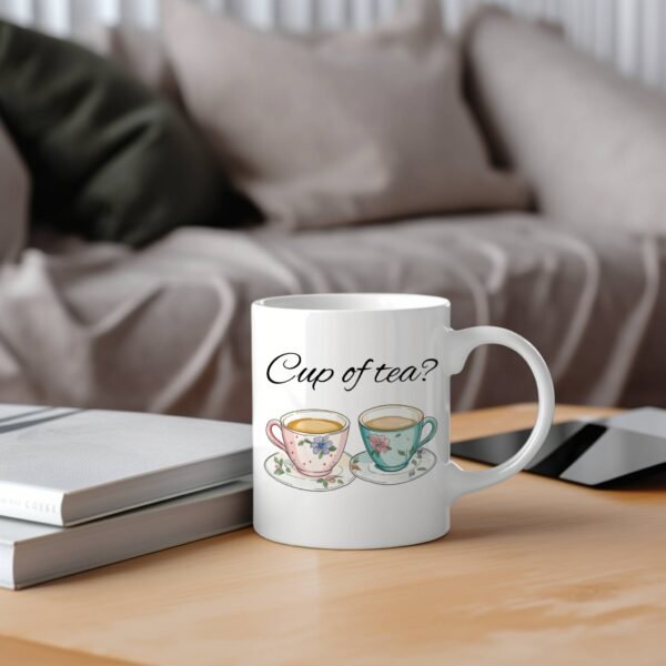 cup of tea mug on wooden table with couch in background