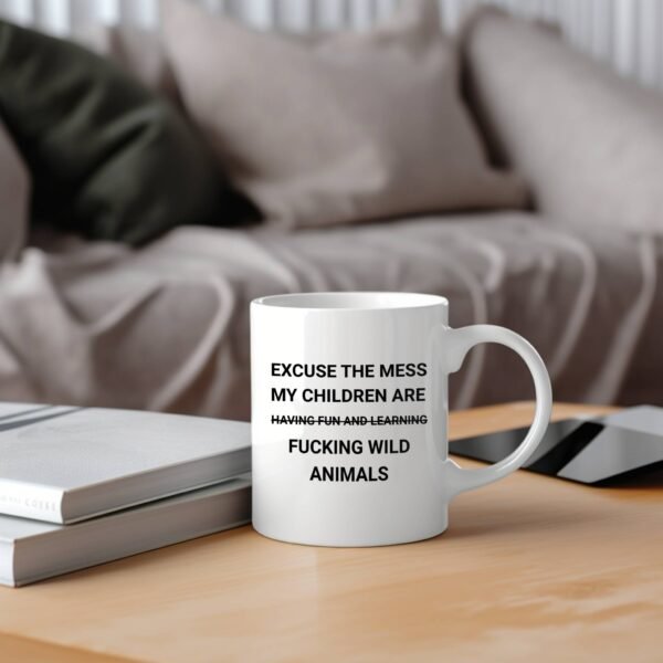 funny parenting mug on wooden table with couch in background
