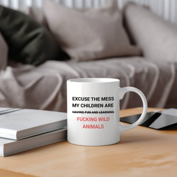 funny parenting mug on wooden table with couch in background